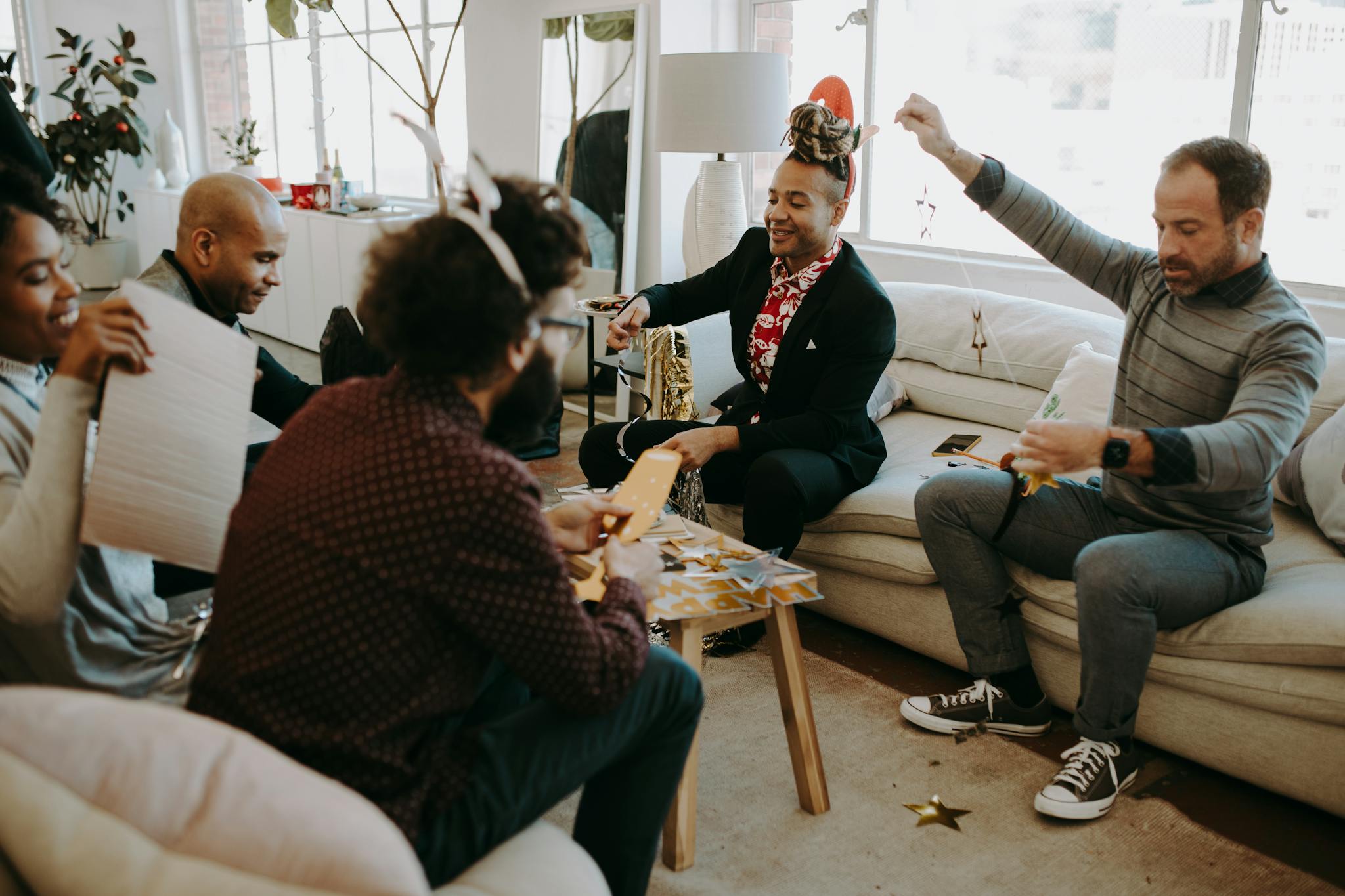 A cheerful group engaged in festive crafting activities indoors.